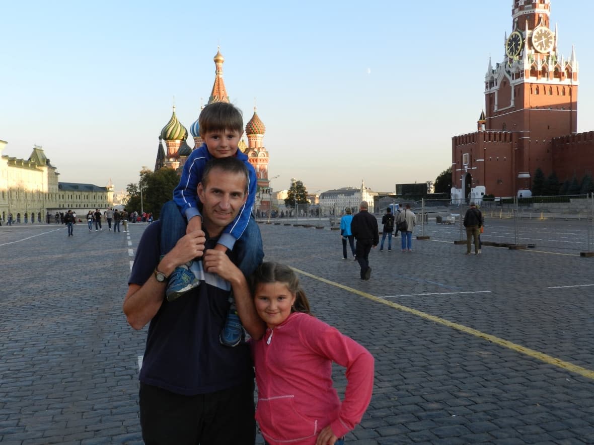 Calgary's Jason Bronius, seen here visiting Moscow's Red Square with his two children when they were younger, has struggled to find a way to transfer child support payments to his ex-wife in Russia ever since Canada's sanctions cut off financial services in and out of Russia.     (Submitted - image credit)