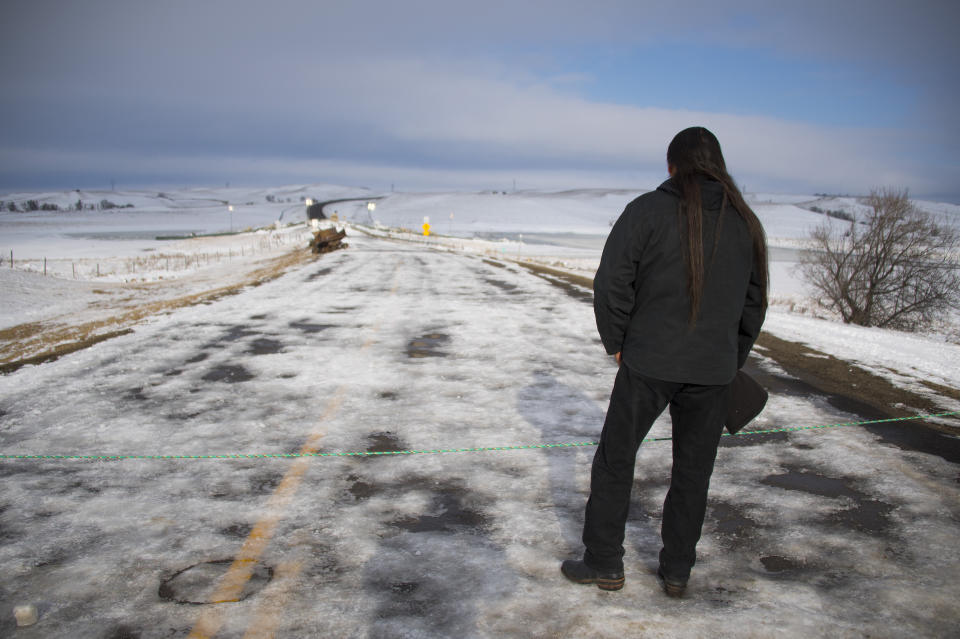 Activist Pete Sands of the Navajo Nation looks out over an area set as a borderline where the police guard a bridge near Oceti Sakowin Camp on the edge of the Standing Rock Sioux Reservation on Dec. 3, 2016, outside Cannon Ball, North Dakota. (Photo: Jim Watson/AFP/Getty Images)