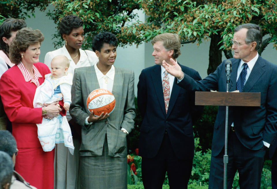 President George Bush honors the University of Tennessee Lady Volunteers, the woman's NCAA Basketball tournament champions, in the White House Rose Garden Monday, April 22, 1991. From left are Volunteers head coach Pat Summitt holder her baby Tyler, center Daedra Charles, guard Dena Head and Vice President Dan Quayle. (AP Photo/Barry Thumma)