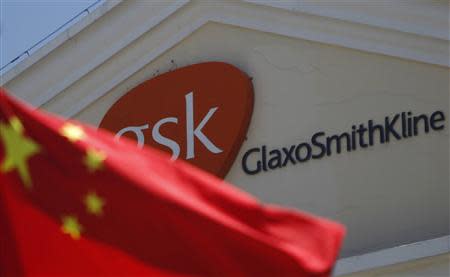 A Chinese national flag is seen in front of a GlaxoSmithKline office building in Shanghai, in this file picture taken July 12, 2013. REUTERS/Aly Song/Files