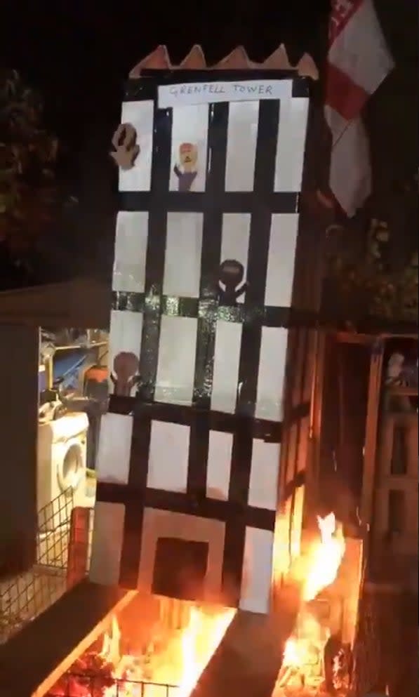 The video, which was seen by the High Court judges, showed figures being burned in a model of the west-London tower (PA Media)
