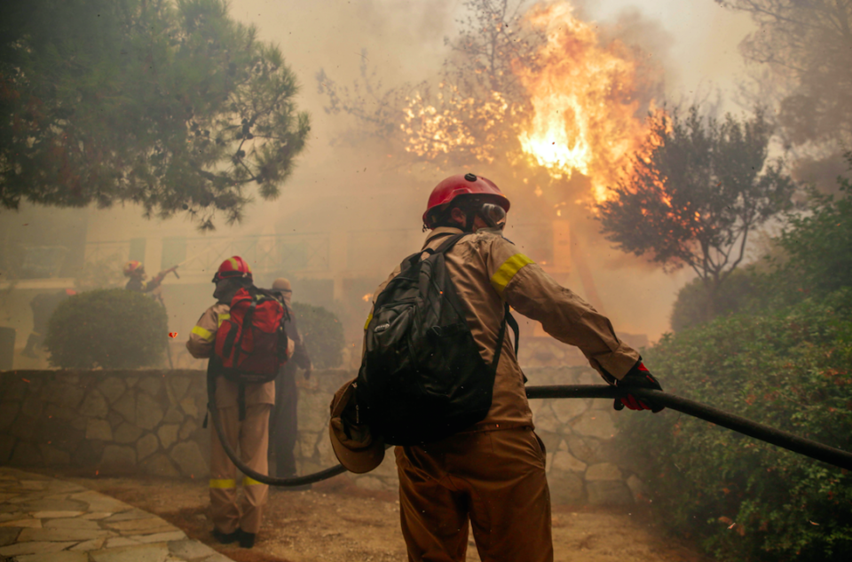 Firefighters battle a blaze at a property outside Athens (Picture: Rex)