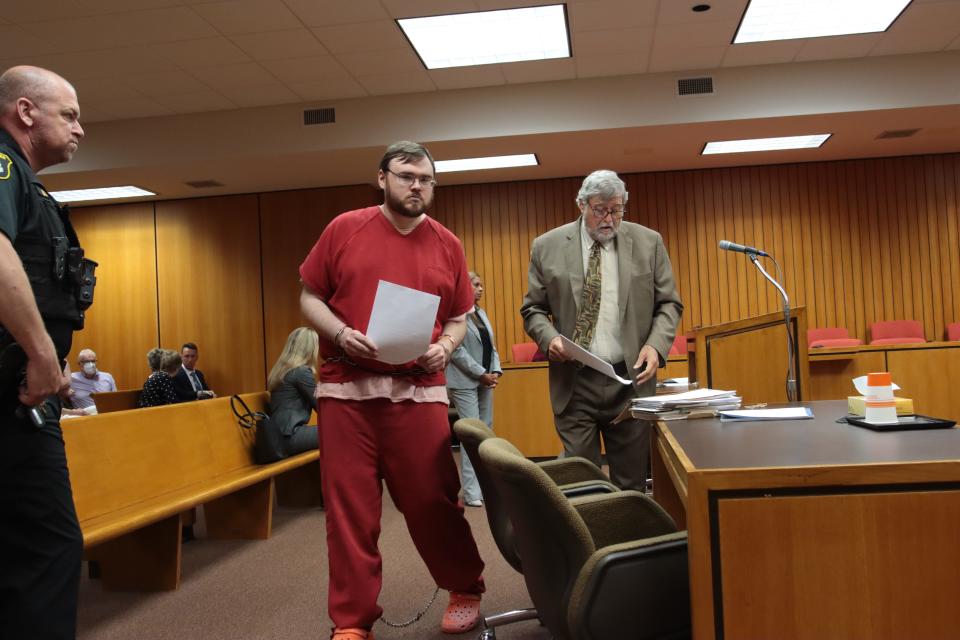 Alarik John Guajardo, center, leaves Lenawee County Circuit Court after being sentenced to life in prison Friday for murdering Glen Harold Meyers on Sept. 16, 2020, in the Adrian Meijer store.