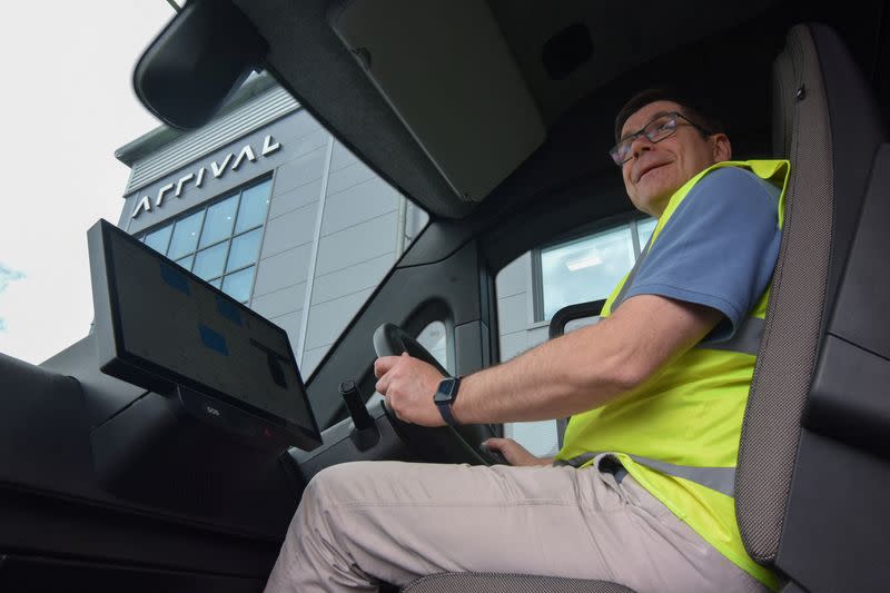 Jules Carter, vice president of the L-Van program at electric van maker Arrival, sits at the wheel of a working prototype vehicle at the company's factory in Bicester