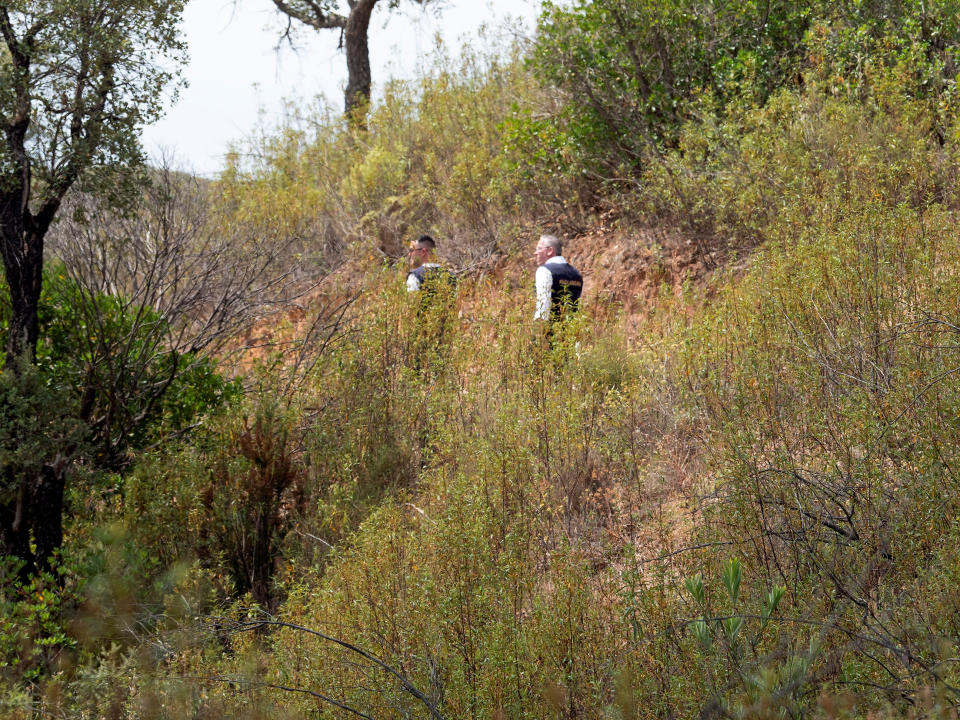 Officers of Portugal's investigative Judicial Police are seen at the site of a remote reservoir where a new search for the body of Madeleine McCann is set to take place, in Silves, Portugal, in this screen grab from a video, May 22, 2023. REUTERS/Luis Ferreira