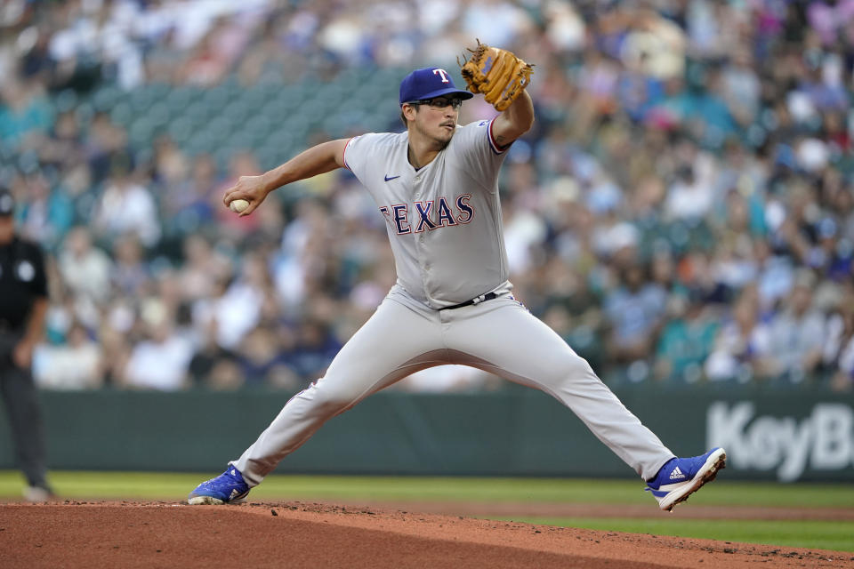 Texas Rangers starting pitcher Dane Dunning throws against the Seattle Mariners during the first inning of a baseball game, Tuesday, July 26, 2022, in Seattle. (AP Photo/Ted S. Warren)