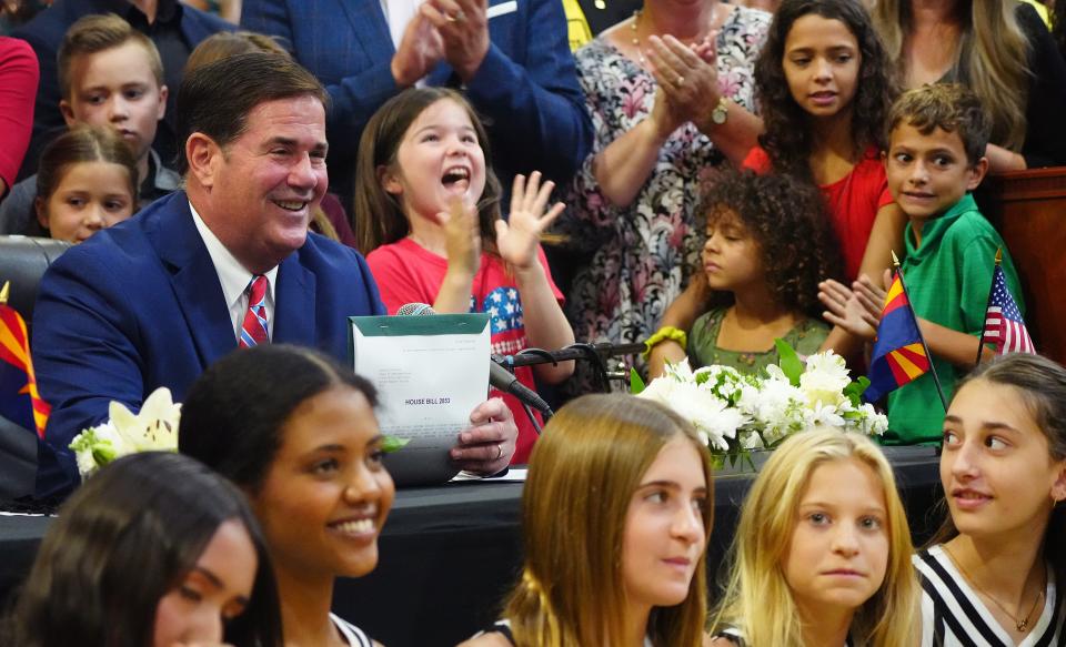 Arizona Gov. Doug Ducey signs the school vouchers expansion bill, HB 2853, at Phoenix Christian Preparatory on Aug. 16, 2022.