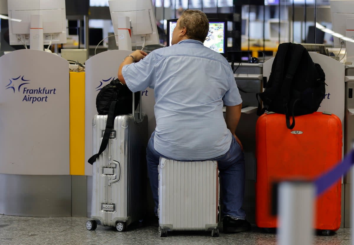 A man waits to check in for a flight at the international airport in Frankfurt, Germany  (EPA)