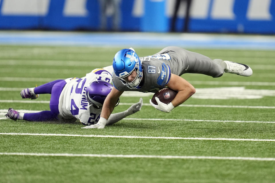 Detroit Lions tight end Sam LaPorta (87) is tackled by Minnesota Vikings safety Camryn Bynum during the first half of an NFL football game, Sunday, Jan. 7, 2024, in Detroit. (AP Photo/Paul Sancya)