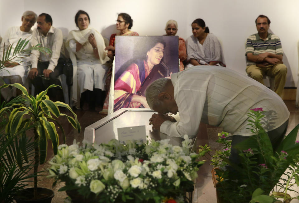 A man pays his last respect to classical Indian musician Kishori Amonkar in Mumbai, India, Tuesday, April 4, 2017. Amonkar, renowned for her innovative interpretation of classical Indian music, has died, one of her students said Tuesday. She was 84. (AP Photo/Rafiq Maqbool)