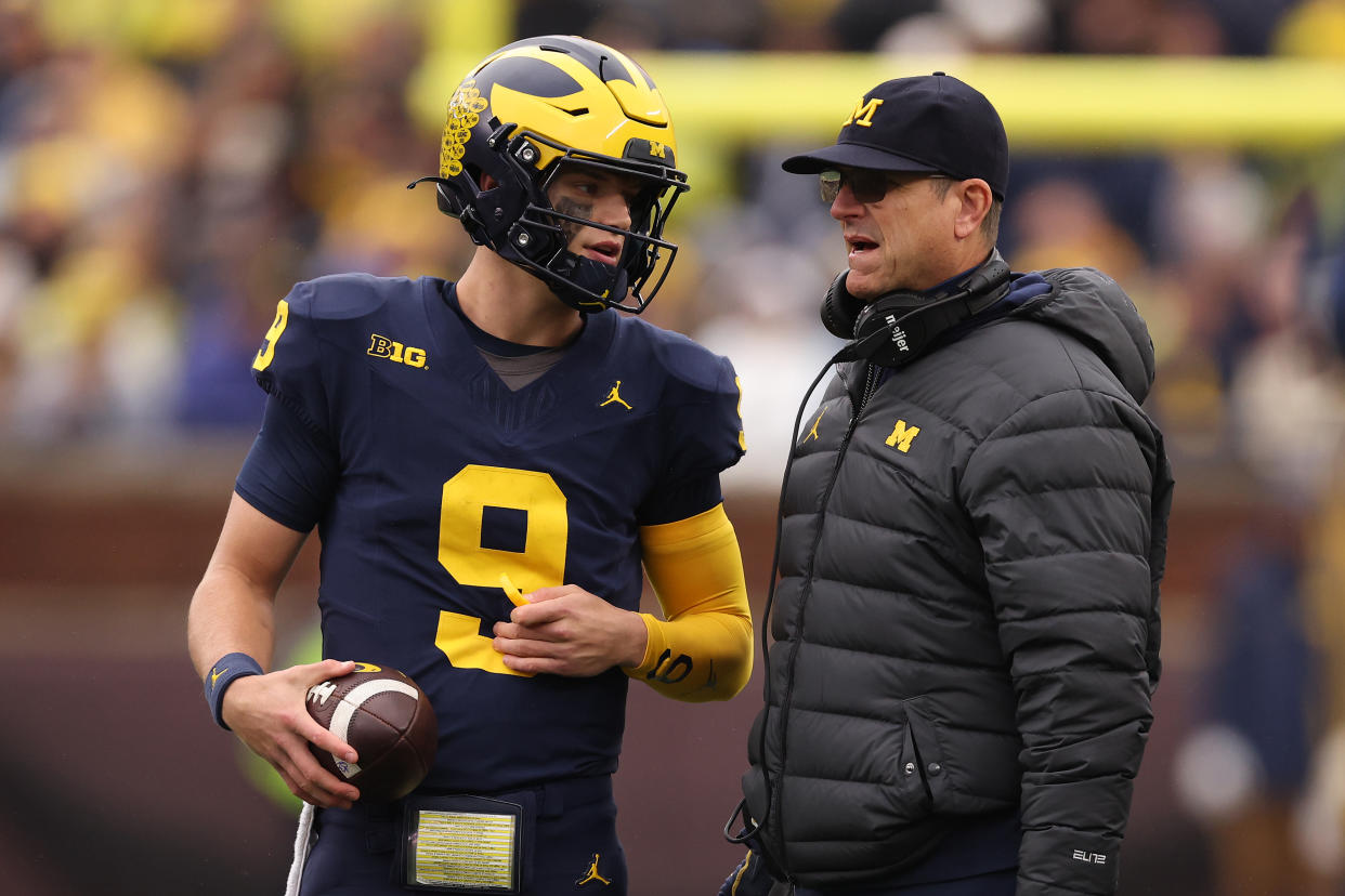 ANN ARBOR, MICHIGAN - OCTOBER 14: Head coach Jim Harbaugh of the Michigan Wolverines talks to J.J. McCarthy #9 during a time out while playing the Indiana Hoosiers at Michigan Stadium on October 14, 2023 in Ann Arbor, Michigan. (Photo by Gregory Shamus/Getty Images)