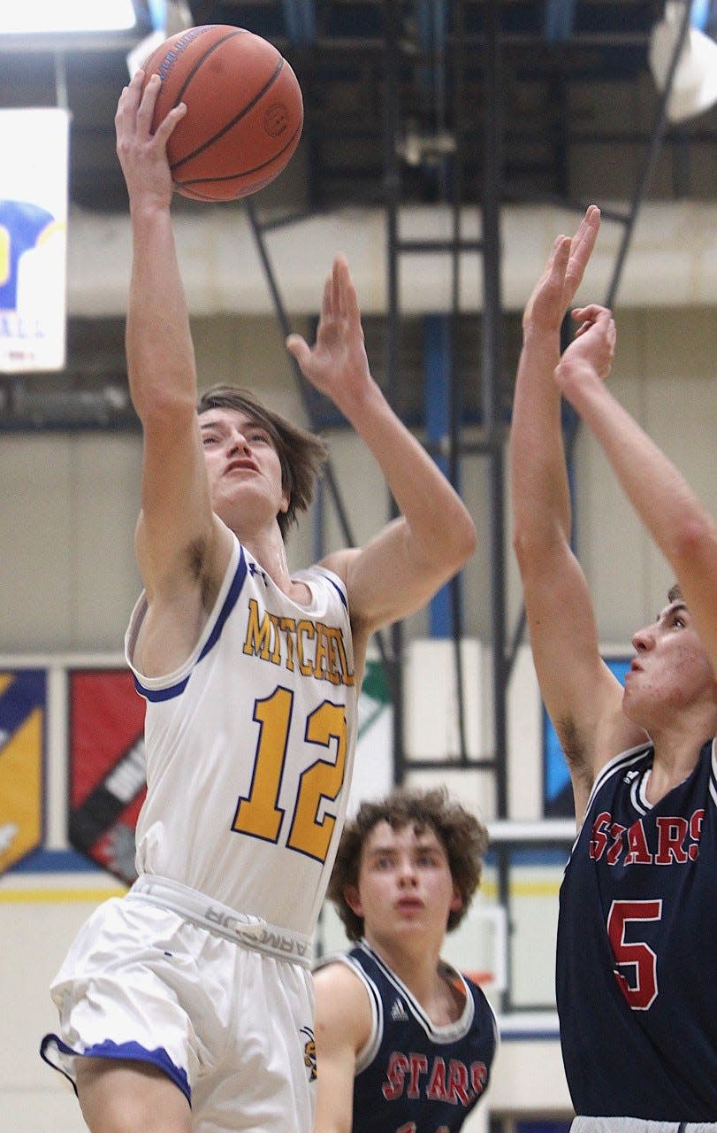 Mitchell senior Andrew Shepherd (12) goes up inside against BNL's Houston Corbin (5) Tuesday night in Mitchell.