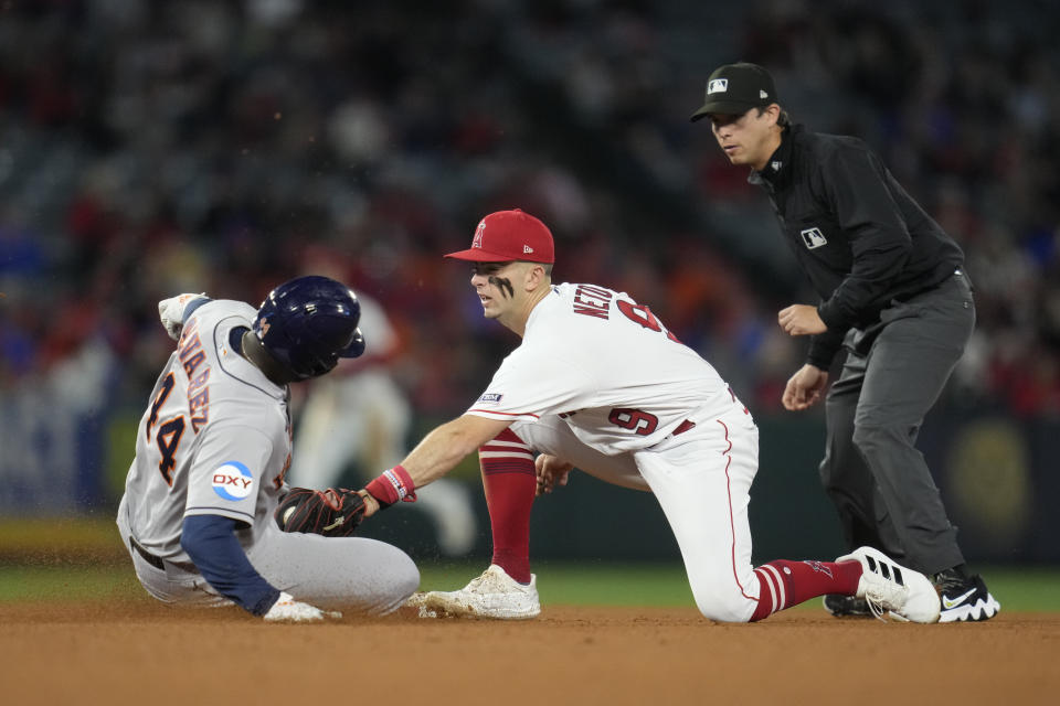 Los Angeles Angels shortstop Zach Neto (9) tags Houston Astros' Yordan Alvarez (44) out at second during the fifth inning of a baseball game in Anaheim, Calif., Monday, May 8, 2023. (AP Photo/Ashley Landis)