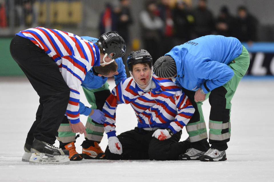 Injured referee Petri Kuusela is helped off the ice during the final match between Sweden and Russia at the Bandy World Championship in Vanersborg, February 3, 2013. Russian player Jevgenij Ivanusjkin collided with Kuusela. REUTERS/Anders Wiklund/Scanpix Sweden (SWEDEN - Tags: SPORT TPX IMAGES OF THE DAY) ATTENTION EDITORS - THIS IMAGE WAS PROVIDED BY A THIRD PARTY. NO COMMERCIAL SALES. SWEDEN OUT. NO COMMERCIAL OR EDITORIAL SALES IN SWEDEN. THIS PICTURE IS DISTRIBUTED EXACTLY AS RECEIVED BY REUTERS, AS A SERVICE TO CLIENTS - RTR3DB0C