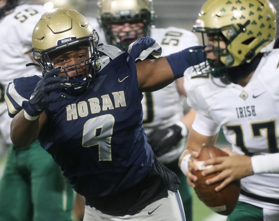 Hoban's Jordan Pritchard-Sewell chases down St. Vincent-St. Mary QB Gabe Mansel during a 2022 regional semifinal.