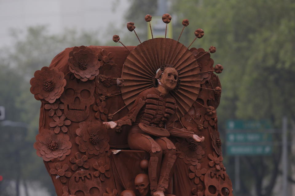 A performer dressed as a pre-columbian deity participates in the Day of the Dead parade in Mexico City, Saturday, Nov. 2, 2019. (AP Photo/Ginnette Riquelme)