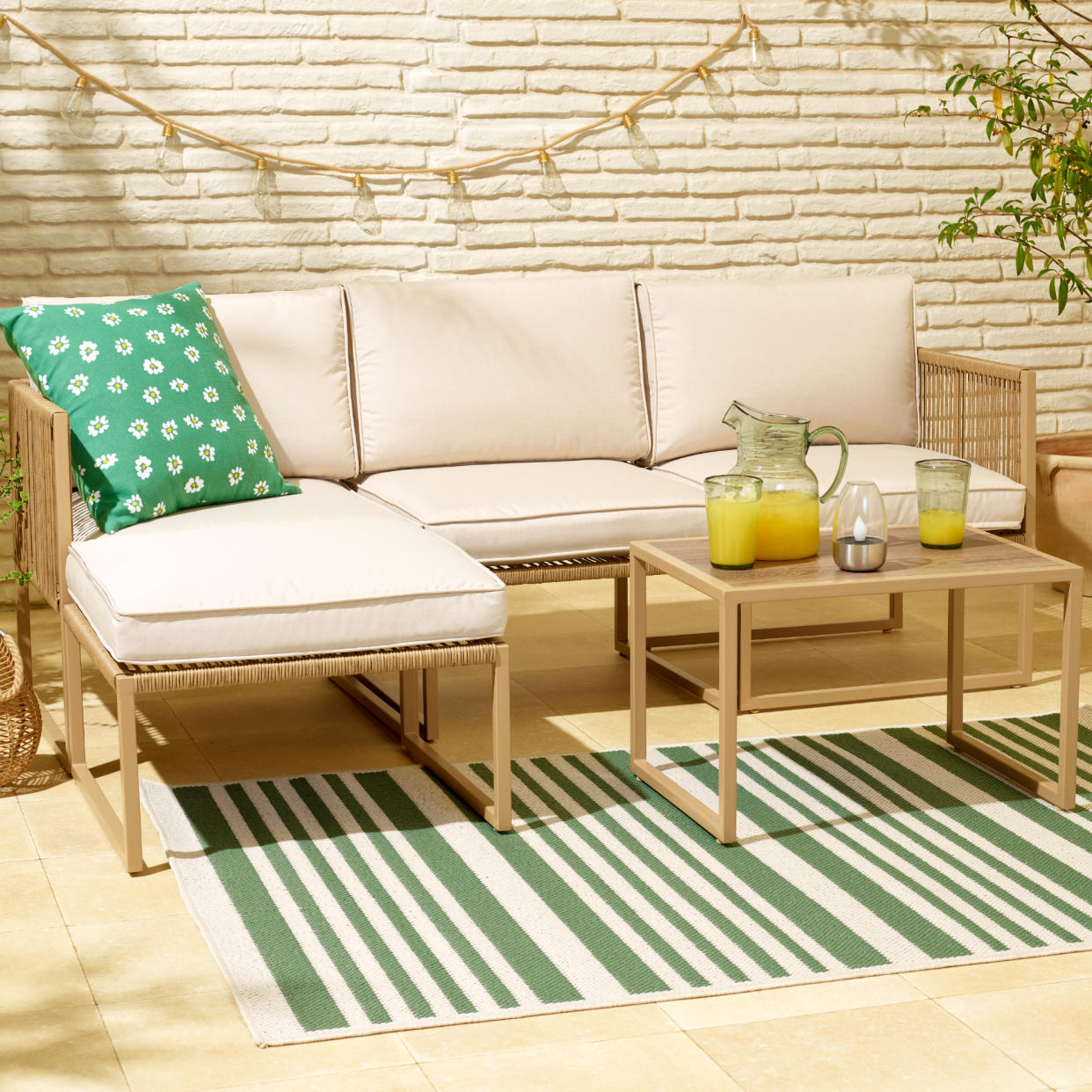  Tesco Florence modular outdoor sofa set on patio with cushions and decorations. 