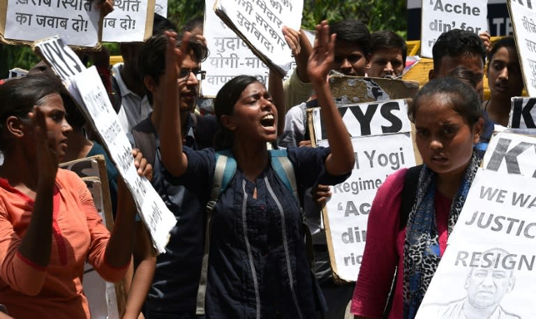 Activists hold placards as they shout slogans during a protest rally outside the Uttar Pradesh state house against the recent deaths of 85 children at a government hospital in northern India that suffered oxygen shortages, in New Delhi on August 16, 2017