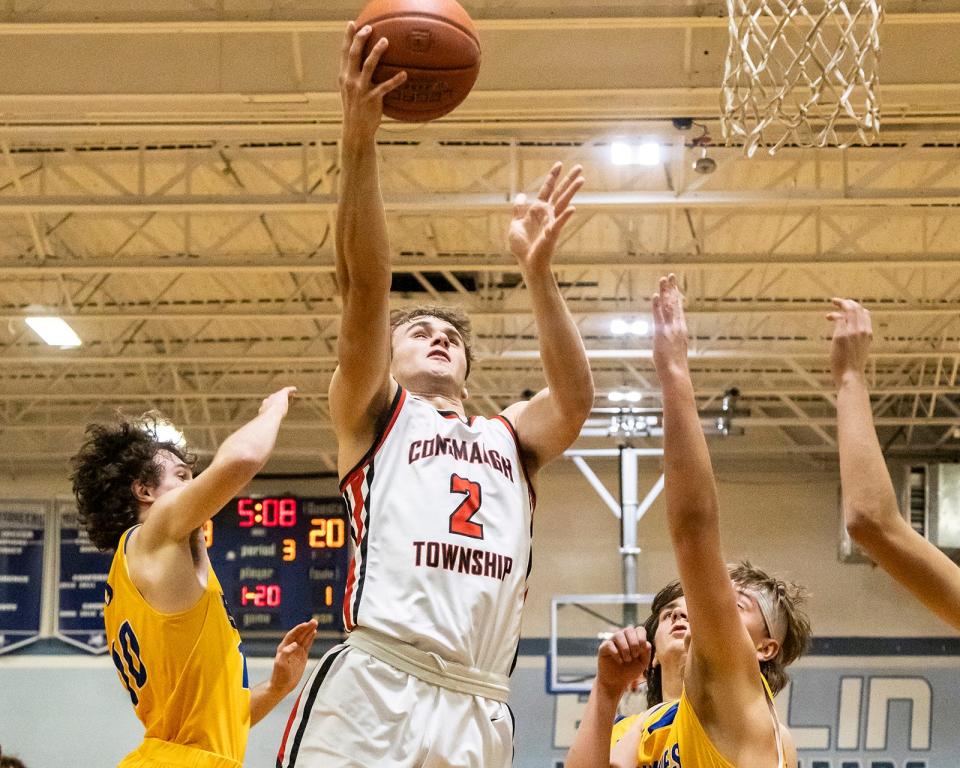 Conemaugh Township senior Jon Updyke goes in for a layup against Northern Garrett defenders Luke Ross (left) and Alex Knauff (right) during the Berlin Veterans' Home Association Holiday Basketball Tournament, Dec 27, in Berlin.