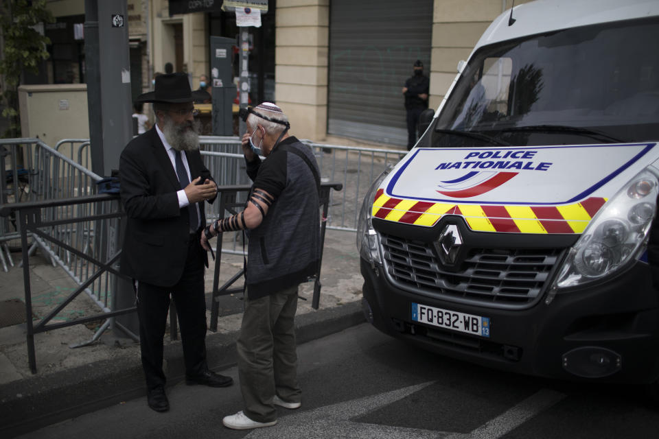 Protesters take a moment to pray during a demonstration in Marseille, southern France, Sunday, April 25, 2021. Crowds gathered Sunday in Paris and other French cities to denounce a ruling by France's highest court that the killer of Jewish woman Sarah Halimi was not criminally responsible and therefore could not go on trial. (AP Photo/Daniel Cole)