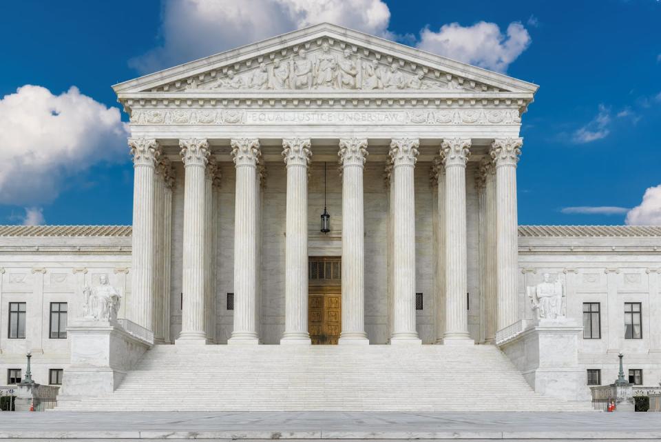 A large white building with eight columns in front.