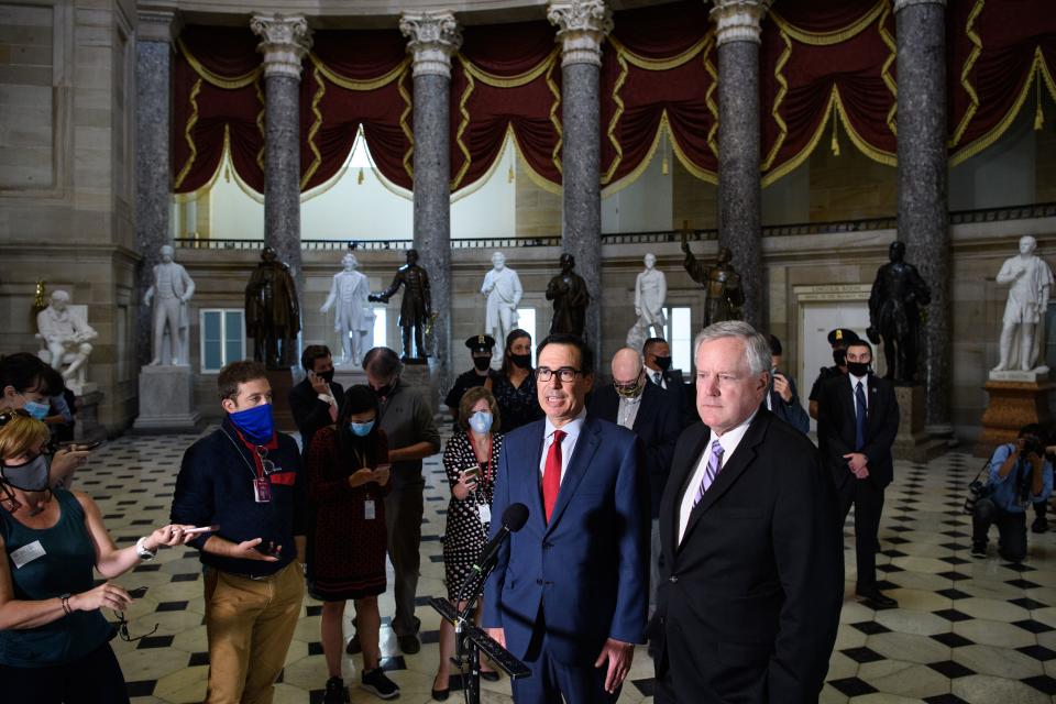 White House Chief of Staff Mark Meadows (R) and US Treasury Secretary Steve Mnuchin speak to the media after meeting with the US Senate Minority Leader and House Speaker on coronavirus relief at the US Capitol in Washington, DC on August 7, 2020. - Democrats urged the White House to stick with negotiations on a new aid plan for Americans facing hardship due to the coronavirus pandemic, after Donald Trump said he is ready to bypass Congress to maintain emergency assistance. (Photo by MANDEL NGAN / AFP) (Photo by MANDEL NGAN/AFP via Getty Images)