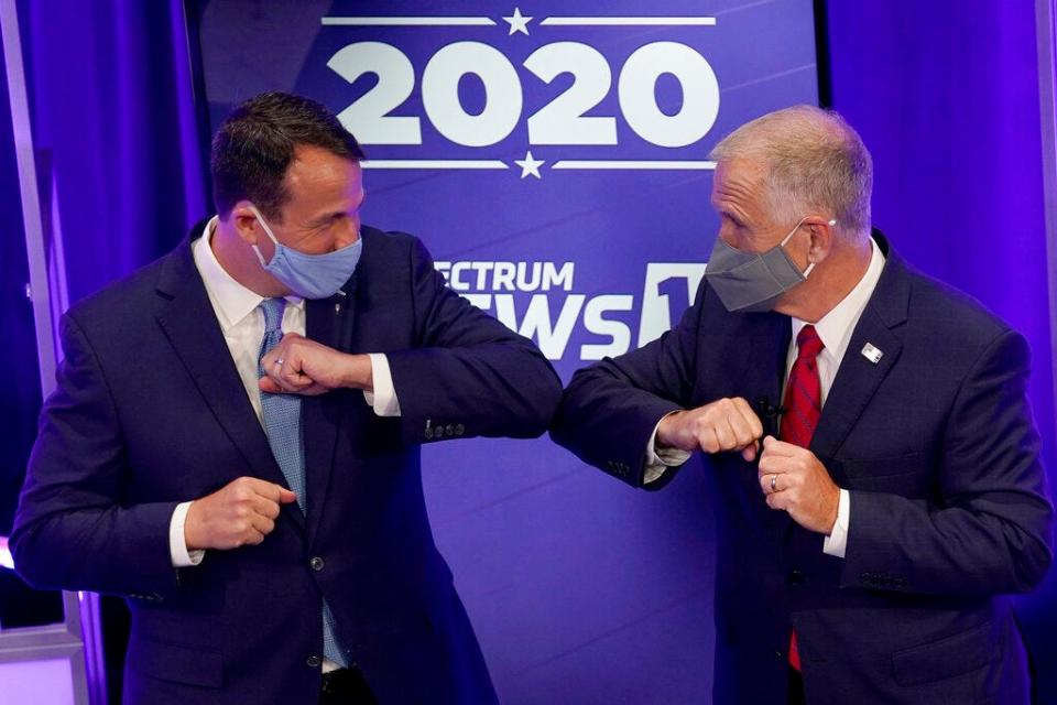 Democratic challenger Cal Cunningham, left, and U.S. Sen. Thom Tillis, R-N.C. greet each other after a televised debate Thursday, Oct. 1, 2020, in Raleigh, N.C. (AP Photo/Gerry Broome, Pool)