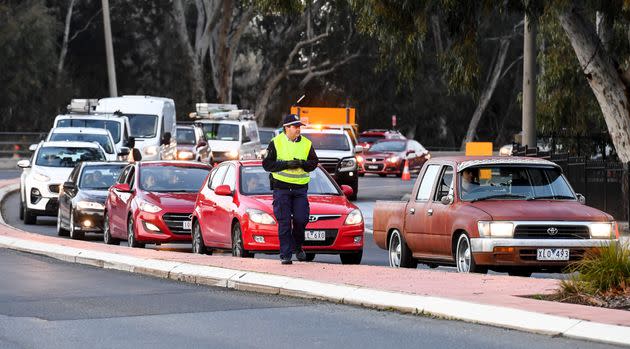 Police in the southern New South Wales (NSW) border city of Albury check cars crossing the state border from Victoria on July 8, 2020  (Photo by WILLIAM WEST/AFP via Getty Images)