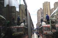 Indigenous ride on buses as they make their way to Plaza Bolivar to take part in a national strike, in Bogota, Colombia, Wednesday, Oct. 21, 2020. Protesters filled the historic square in Colombia’s capital Wednesday to demonstrate against the government’s handling of a wide range of issues including the economic fallout of the pandemic and implementation of the peace accord. (AP Photo/Fernando Vergara)