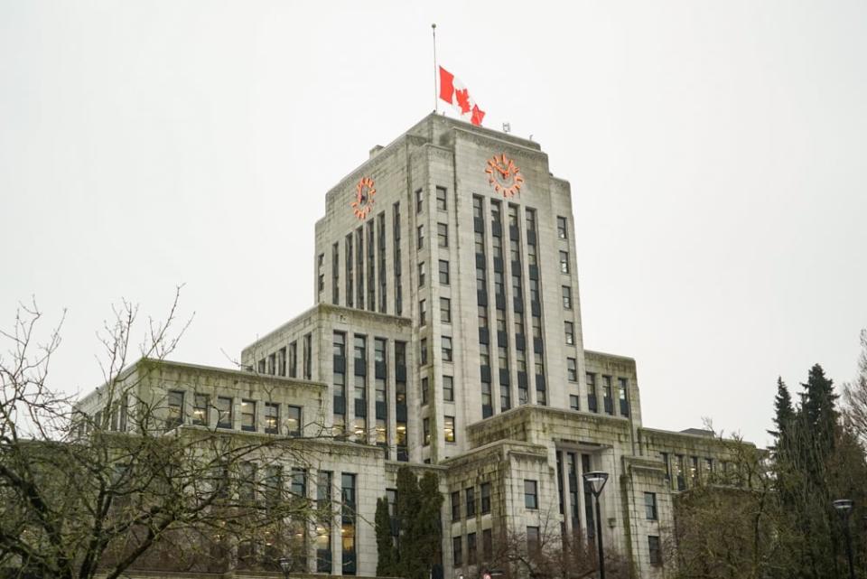 The flag at Vancouver city hall flies at half mast on Monday, Jan. 11, in memory of longtime employee Gord Dolyniuk who died on the job Friday.