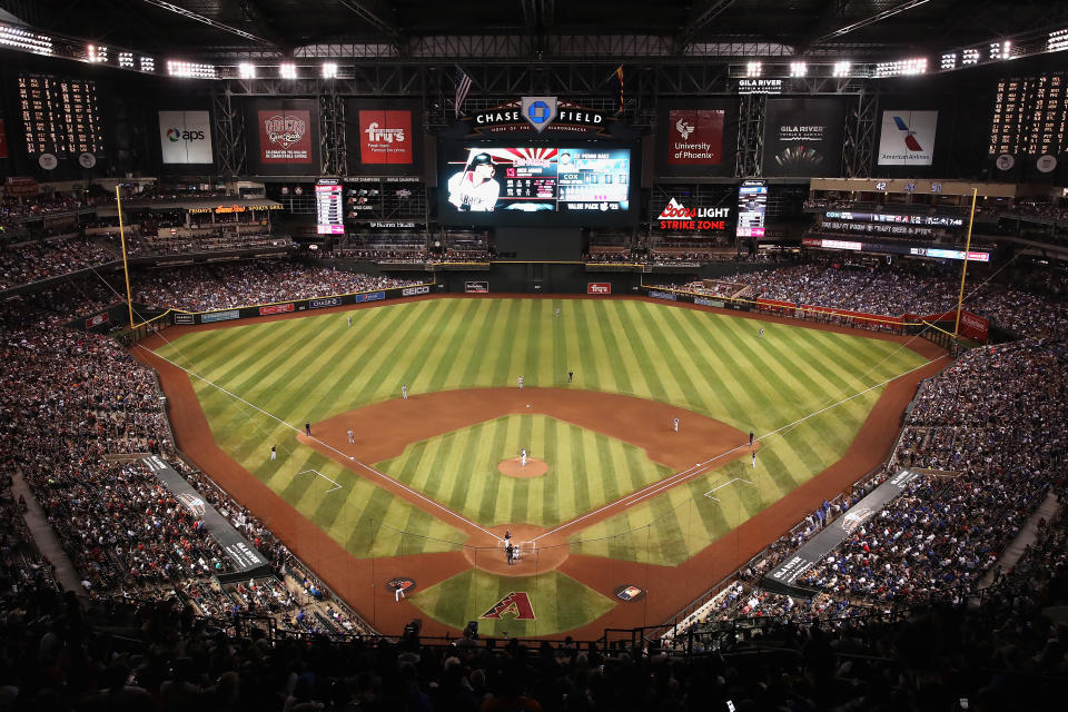 PHOENIX, ARIZONA - AUGUST 31:  General view of action as relief pitcher Pedro Baez #52 of the Los Angeles Dodgers pitches against Nick Ahmed #13 of the Arizona Diamondbacks during the seventh inning of the MLB game at Chase Field on August 31, 2019 in Phoenix, Arizona. The Diamondbacks set an attendance record with a sold-out crowd of 50,180.  (Photo by Christian Petersen/Getty Images)