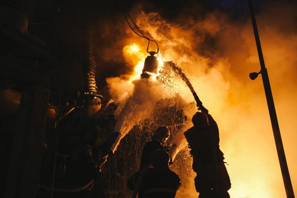 Rescuers extinguishing a fire at a critical power infrastructure after a drone attack in Kyiv (UKRAINIAN EMERGENCY SERVICE/AFP)