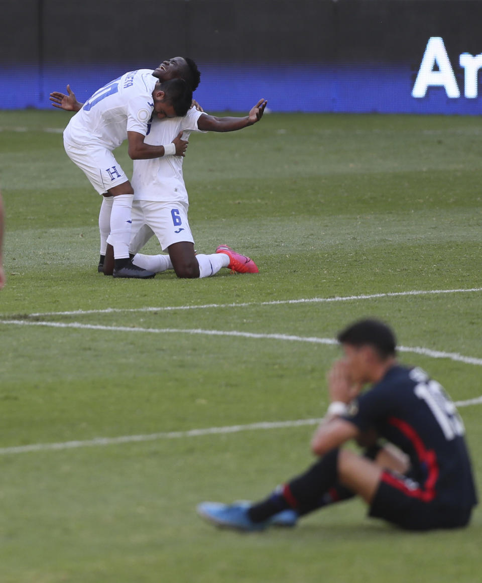 Honduras' Carlos Argueta, top left, and Jonathan Nunez celebrates at the end of a Concacaf Men's Olympic qualifying championship semi-final soccer match in Guadalajara, Mexico, Sunday, March 28, 2021. Honduras defeated United States 2-1, qualifying for the upcoming Tokyo Olympics. (AP Photo/Fernando Llano)