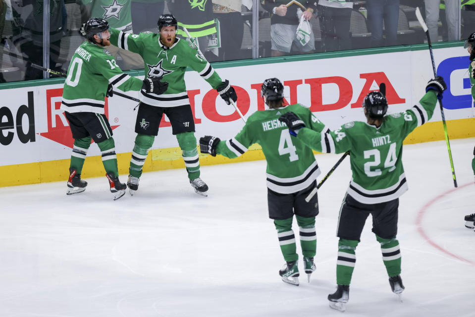 Dallas Stars' Ty Dellandrea (10), Miro Heiskanen (4) and Roope Hintz (24) celebrate with Joe Pavelski (16), who scored against the Vegas Golden Knights in overtime of Game 4 of the NHL hockey Stanley Cup Western Conference finals Thursday, May 25, 2023, in Dallas. (AP Photo/Gareth Patterson)