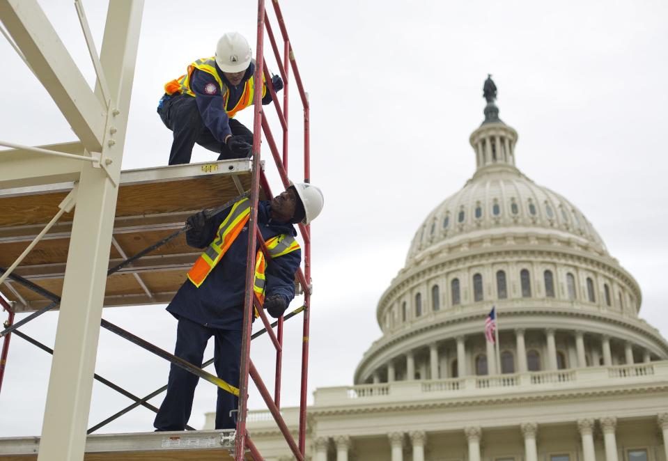 FILE - In this Dec. 8, 2016, file photo, construction continues for the Inauguration and swearing-in ceremonies for President-elect Donald Trump on the Capitol steps in Washington. It’s typically an unquestioned honor to participate in the inauguration of an American president. This time, though, it’s different. The sharp divisions over Donald Trump’s election have politicians, celebrities and even high school students debating whether taking part in the inauguration is a political act that demonstrates support for the new president and his agenda or a nonpartisan tribute to democratic traditions and the peaceful transfer of power. (AP Photo/Pablo Martinez Monsivais, File)