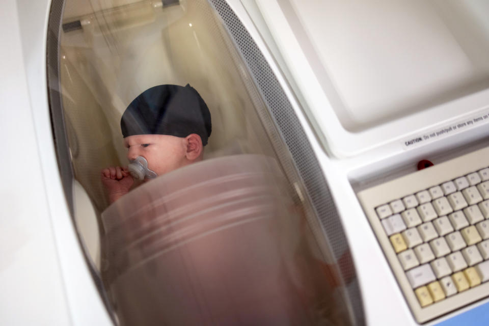 Researchers calculate two-week-old Jameson Hardee’s body fat percentage in a machine called a Pea Pod. Jameson’s mother, Julie Hardee, works in the lab, and volunteered Jameson to demonstrate how measurements are taken. (Kathleen Flynn for NBC News)