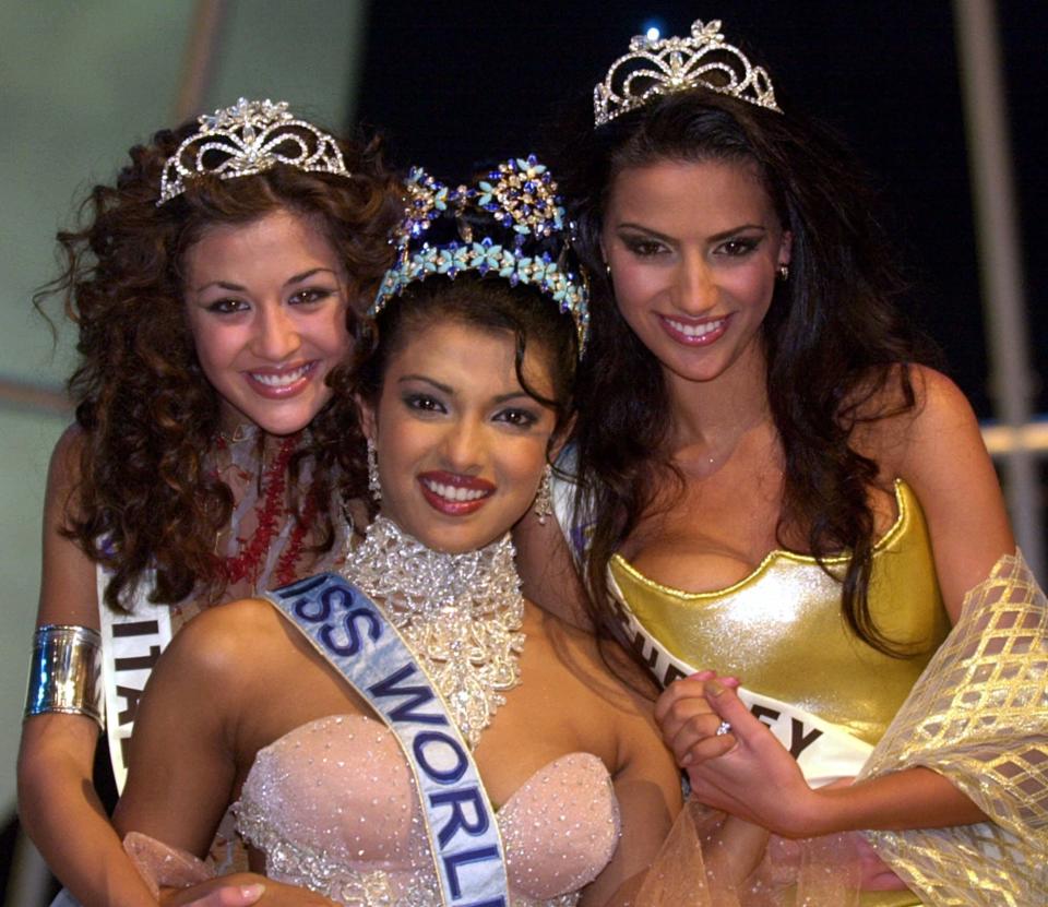 Miss India, Priyanka Chopra, 18, the new Miss World, centre, poses with runner up Miss Italy Giorgia Palmas, 18, left, and Miss Turkey Yuksel Ak, 20, at London's Millennium Dome Thursday, November 30, 2000. (AP Photo/Adam Butler)