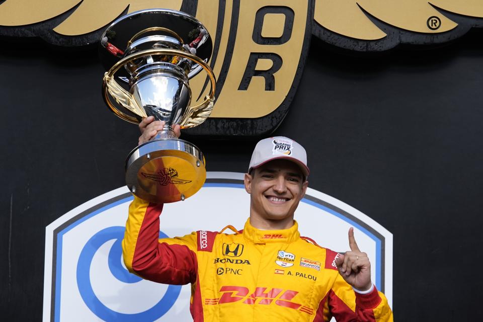 Alex Palou, of Spain, holds the trophy after winning the IndyCar Grand Prix auto race at Indianapolis Motor Speedway, Saturday, May 11, 2024, in Indianapolis. (AP Photo/Darron Cummings)