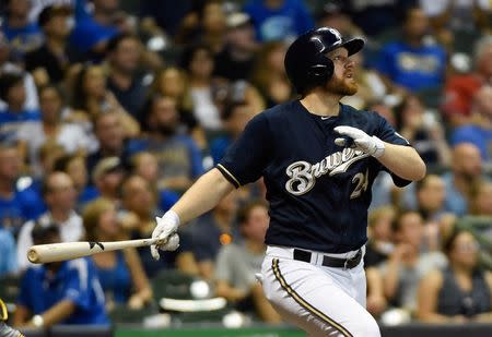 Sep 2, 2015; Milwaukee, WI, USA; Milwaukee Brewers first baseman Adam Lind (24) hits a solo home run in the fifth inning against the Pittsburgh Pirates at Miller Park. Mandatory Credit: Benny Sieu-USA TODAY Sports