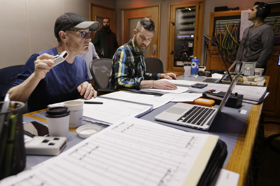 In this Oct. 21, 2019, photo, composer Gordy Haab, left, oversees the recording of his video game soundtrack with the help of Sam Smythe, center, in Nashville, Tenn. Music City is earning a new reputation as Soundtrack City. And more production companies, including Netflix, Showtime, Sony and Focus Features, have been lured to Nashville to record music for movies, TV and video games in the last year thanks to a new incentive program. (AP Photo/Mark Humphrey)