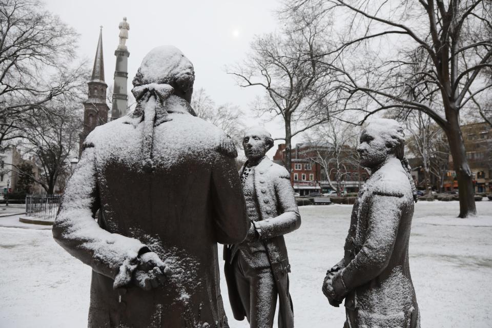 Statues of George Washington, Marquis de Lafayette and Alexander Hamilton on The Green in Morristown, NJ are lightly coated from some snow that fell this morning on January 20, 2022.