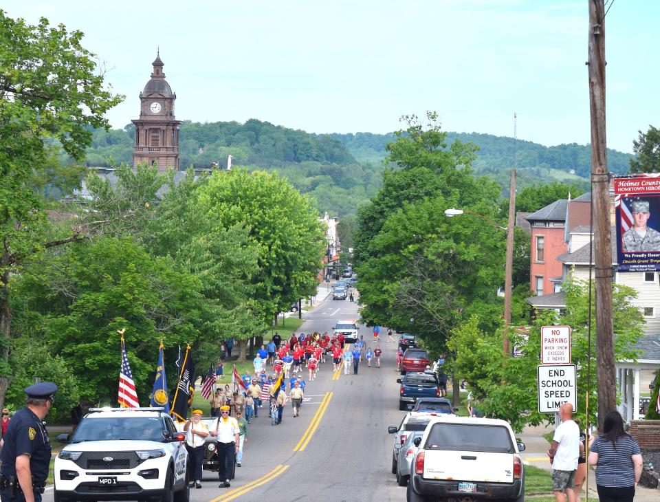 Residents watched from the sidewalks as the color guard, Buckeye Council Scouts, Silver Sneakers and the West Holmes High School Marching Band marched through town en route to a Memorial Day presentation at Oak Hill Cemetery in Millersburg Monday morning.