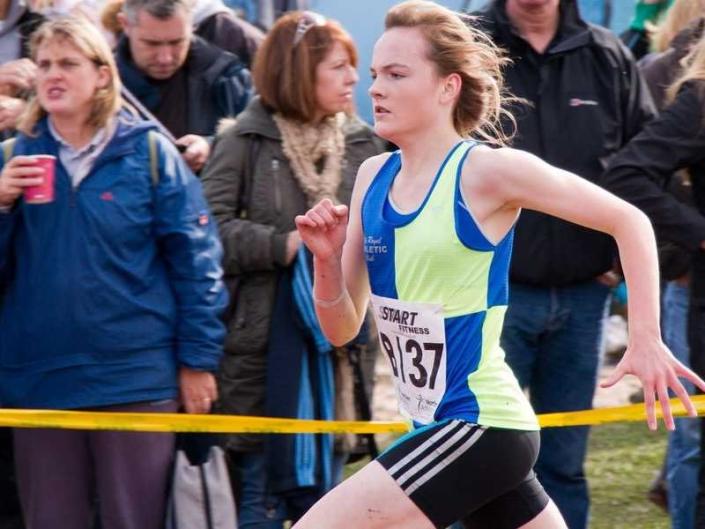 woman running in a relay race