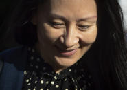 Meng Wanzhou, center, chief financial officer of Huawei Technologies, leaves her home in Vancouver, on Friday, Sept. 24, 2021. Wanzhou has resolved criminal charges against her as part of a deal with the U.S. Justice Department that could pave the way for her to return to China and that concludes a case that roiled relations between Washington and Beijing. (Darryl Dyck/The Canadian Press via AP)