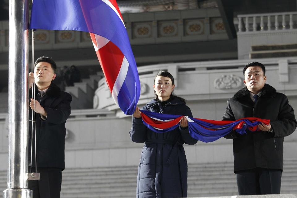 Exemplary workers during the national flag-hoisting ceremony during celebrations for the New Year, at Kim Il Sung Square in Pyongyang, North Korea, early Friday, Jan., 1, 2021. (AP Photo/Jon Chol Jin)