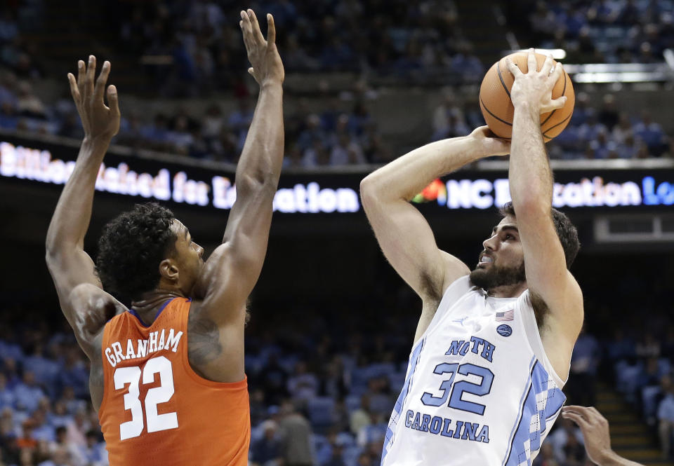 North Carolina’s Luke Maye (32) shoots while Clemson’s Donte Grantham (32) defends during the first half of an NCAA college basketball game in Chapel Hill, N.C., Tuesday, Jan. 16, 2018. (AP Photo/Gerry Broome)