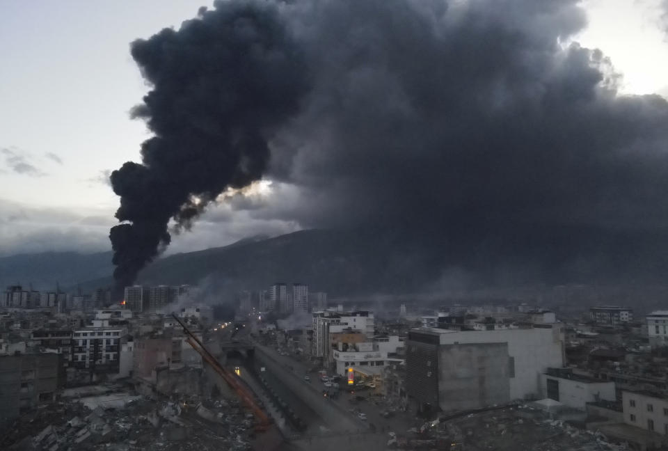 <p>A large fire that broke out at a section of a port in the earthquake-stricken town was raging for a second day running, in Iskenderun, southern Turkey, Tuesday, Feb. 7, 2023. Television images on Tuesday showed thick black smoke rising from burning containers at Iskenderun Port. Reports said the fire was caused by containers that toppled over during the powerful earthquake that struck southeast Turkey on Monday. Turkey's state-run Anadolu Agency said a Turkish Coast Guard vessel was assisting efforts to extinguish fire. (Serdar Ozsoy/Depo Photos via AP)</p> 