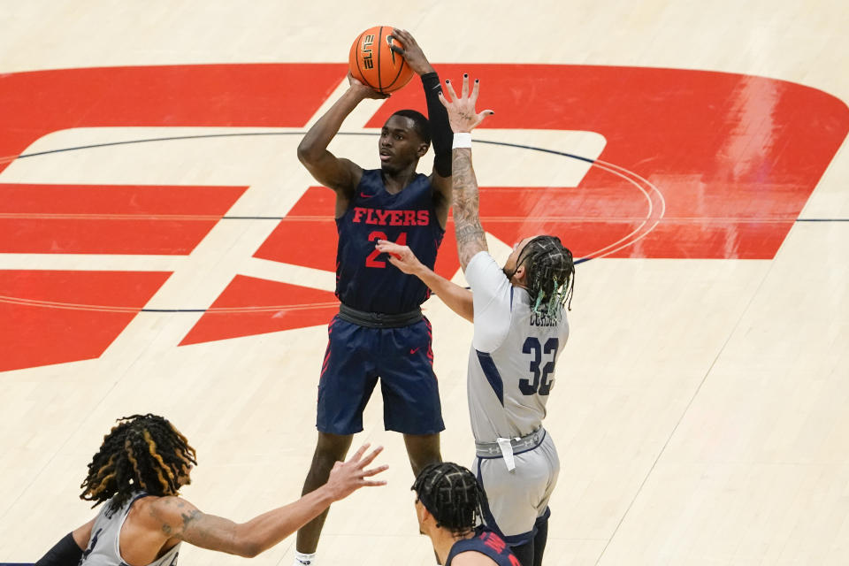 Dayton guard Kobe Elvis (24) shoots as Robert Morris guard Josh Corbin (32) defends during the second half of an NCAA college basketball game, Saturday, Nov. 19, 2022, in Dayton, Ohio. (AP Photo/Joshua A. Bickel)