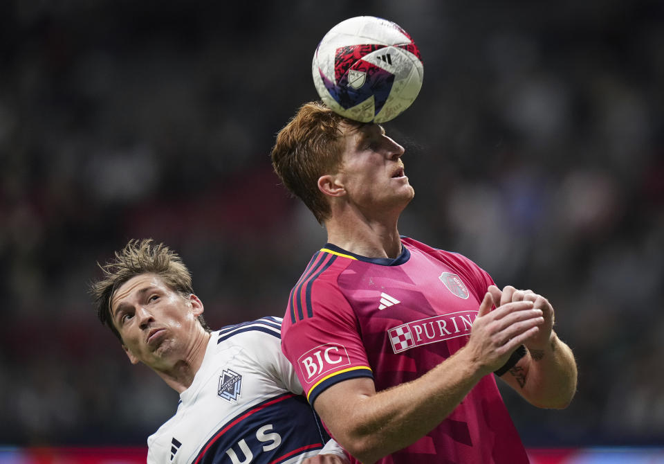 St. Louis City's Tim Parker, right, gets his head on the ball as Vancouver Whitecaps' Ryan Gauld watches during the second half of an MLS soccer match Wednesday, Oct. 4, 2023, in Vancouver, British Columbia. (Darryl Dyck/The Canadian Press via AP)