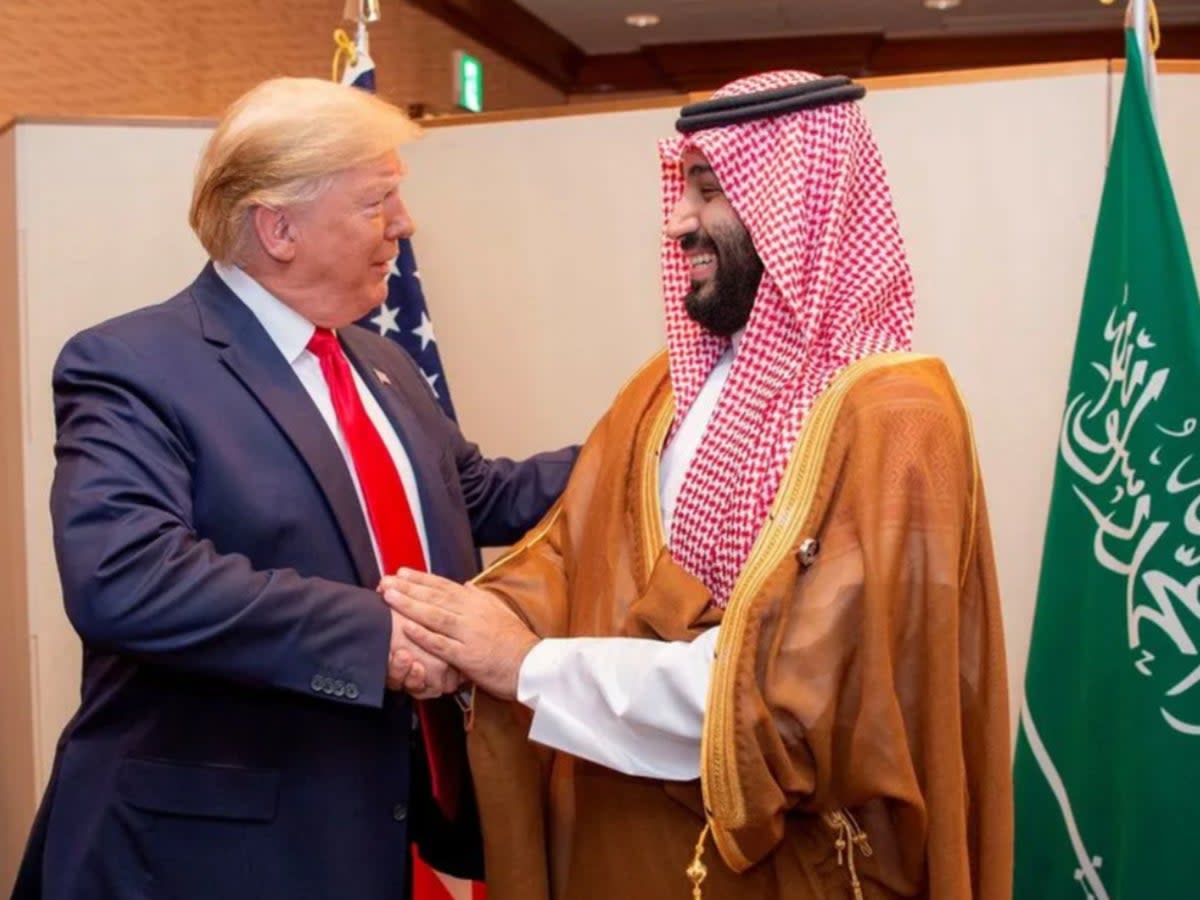 Donald Trump and Saudi Arabia’s crown prince Mohammed bin Salman shaking hands at the G20 leaders summit in Osaka, Japan, in 2019 (Reuters)